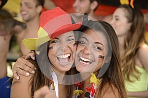 Girlfriends sport soccer fans celebrating.