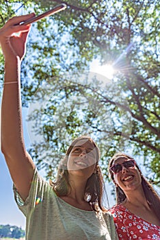 Girlfriends taking selfie together having fun outdoors concept of modern women friendship lifestyle female best friends happy