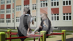 Girlfriends talking in schoolyard