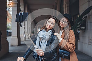 Girlfriends tourist taking photo selfie together on smartphone mobile. Blogger travels in europe city. Vacation holiday friendship