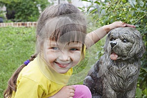 Girlie near to concrete dog photo