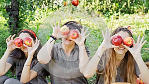 Girls with Apple in the Apple Orchard. Beautiful sisters with Organic Apple in the Orchard. Harvest Concept. Garden, teenagers