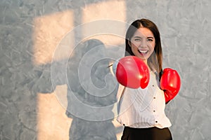 Girls Asian businessman wearing boxing gloves red hand displayin