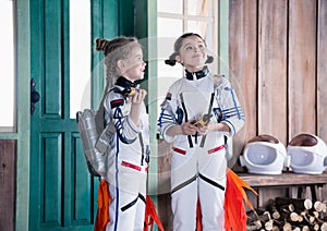 Girls in astronaut costumes with jetpacks