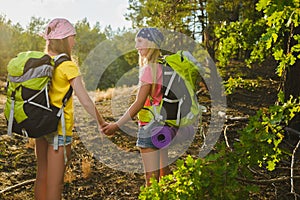 Girls with backpack in hill forest. Adventure, travel, tourism concept