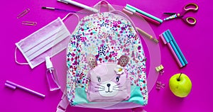 Girls backpack with school supplies and sanitiser and medical protective mask stop motion animation. Back to school after quaranti