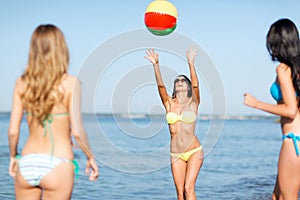 Girls with ball on the beach