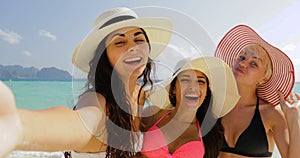 Girls On Beach Taking Selfie Photo On Cell Smart Phone, Cheerful Women In Bikini and Straw Hats On Summer Holiday