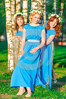 Girls in blue dresses with wreaths on heads
