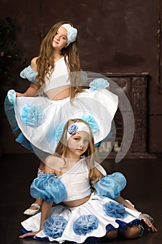 Girls in blue with white tops and skirts