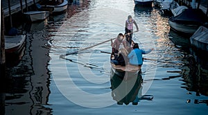 Girls on boat on Venetian canal