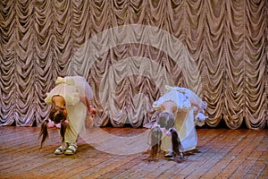 Girls bow to the audience after the performance on stage. The end of the song in the vocal competition. Young singers on the big