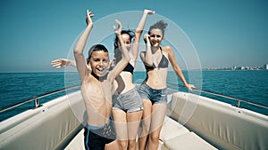 Girls and a boy on a luxury yacht dancing