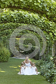 Girls And Bride Squatting Under Ivy Arches