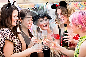 Girls at Carnival parade clinking glasses with champagne