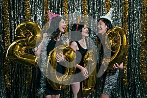 Girls carrying gold colored numbers 2019