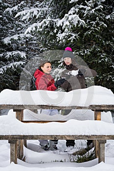 girls celebrating with wine outside in the snow