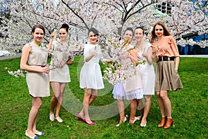 Girls with champagne celebrating in sakura's garden.