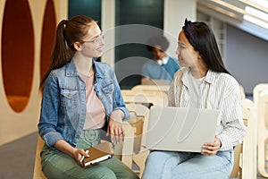 Girls chatting in lecture room