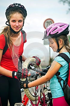 Girls children cycling Family pump up bicycle tire.