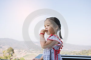 Girls children are enjoying eating strawberry with happy in garden