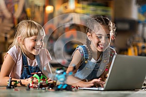 Girls cooperating while making a robot