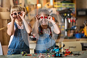 Girls cooperating while making a robot