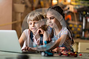 Girls cooperating while making a robot