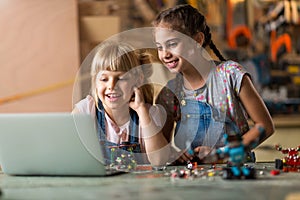 Girls cooperating while making a robot