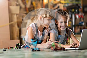 Girls cooperating while making a robot photo