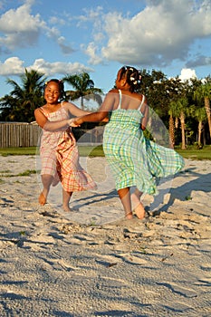 Girls dancing on sand at beach