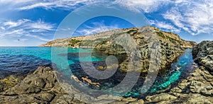 Girls dive on Baunty beach, cape Fiolent in Sevastopol, Crimea on a background of rocky shores. The concept of an travel, relax,