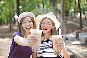 Girls drinking bubble tea and enjoy summer vacation