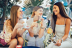 Girls drinking cocktail in cafe and having fun