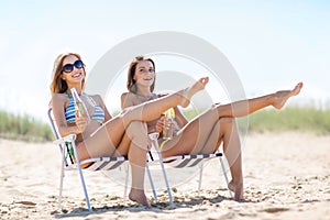 Girls with drinks on the beach chairs