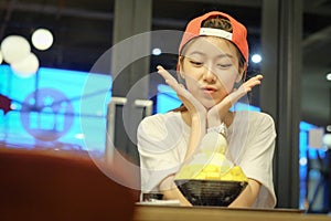 Girls are eating Bingsu Mango Cheese - Korean Dessert