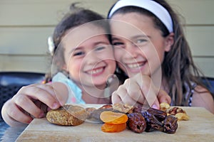 Girls Eating  Dried Fruit Together on Tu Bishvat Jewish Holiday