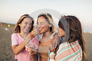 Girls eating ice cream on the beach