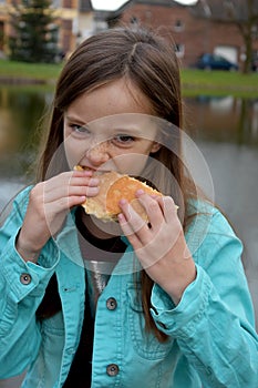 Girl eats a slice of crumble cake photo