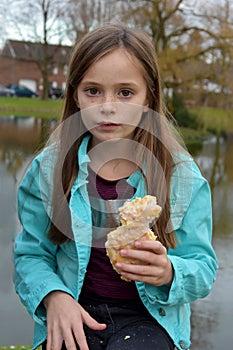 Girl eats a slice of crumble cake photo