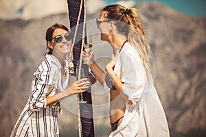 Girls enjoy the vacation on a yacht.