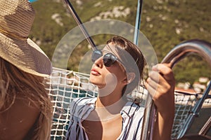 Girls enjoy the vacation on a yacht.