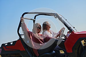 girls enjoying a beautiful sunny day while driving an off-road car