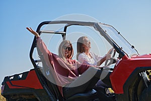 girls enjoying a beautiful sunny day while driving an off-road car