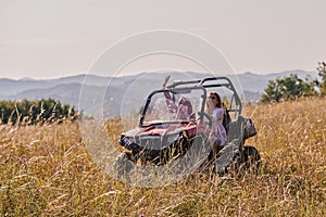 girls enjoying a beautiful sunny day while driving an off-road car