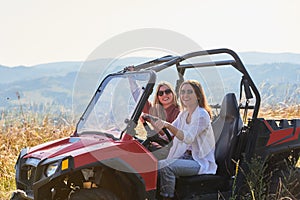 girls enjoying a beautiful sunny day while driving an off-road car