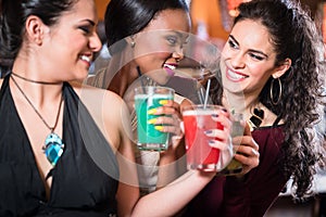 Girls enjoying nightlife in a club, drinking cocktails