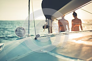 Girls enjoying sunset on sea and yacht. Abstract sailing background