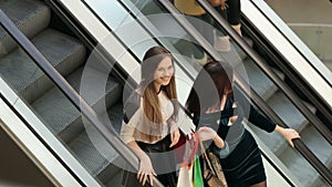 Girls on the escalator in the big shopping center.