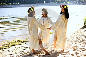 Girls in ethnic clothes with wreath of flowers celebrating